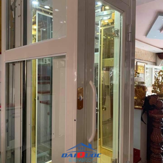 THANG MÁY HOMELIFT LỒNG KÍNH CỬA MỞ TAY
